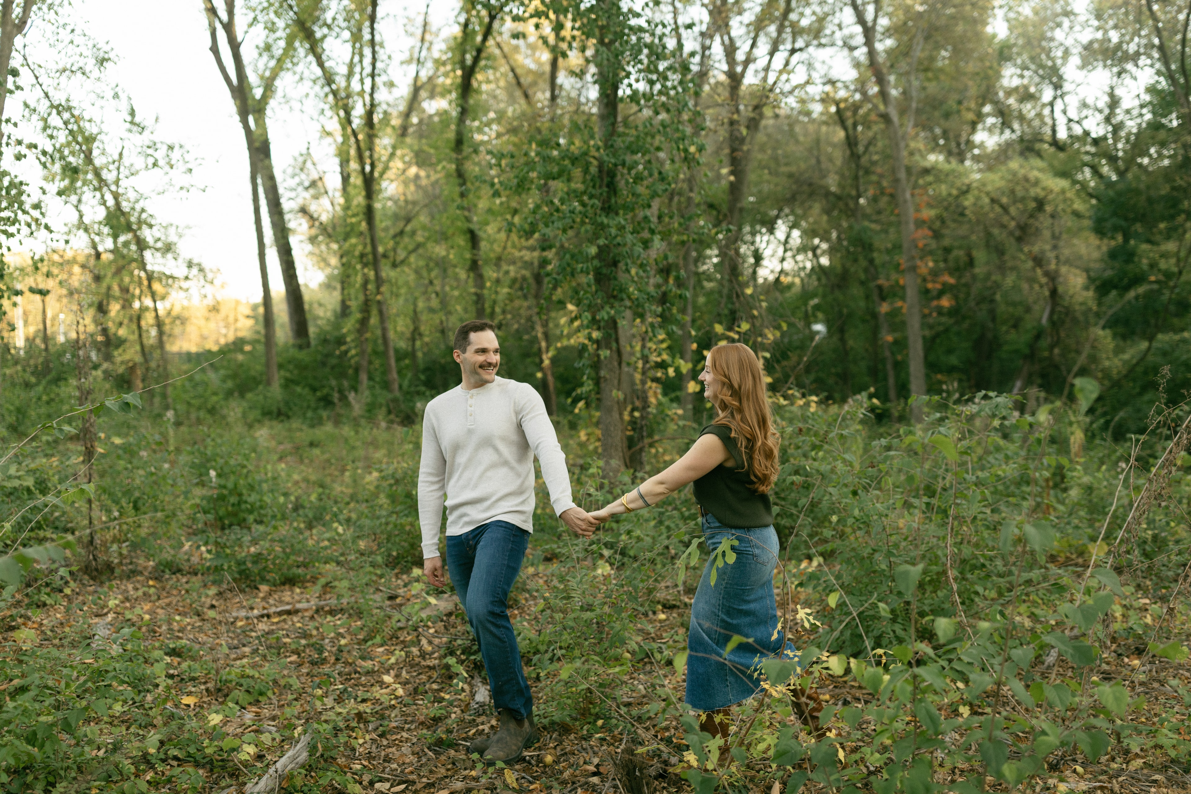 Alex and Claire holding hands in trees